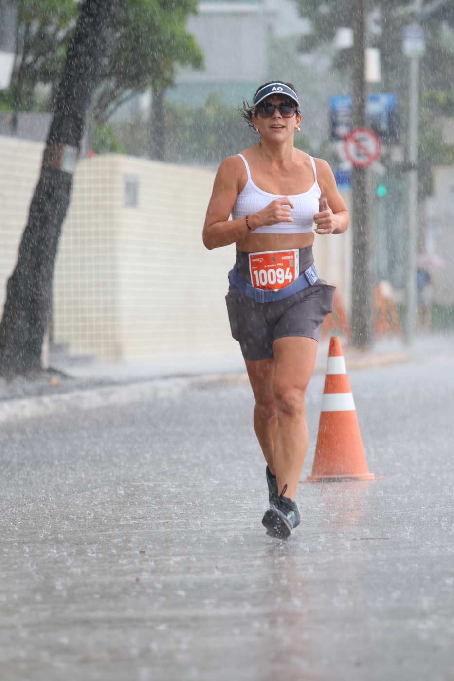Mari running through rain at a race